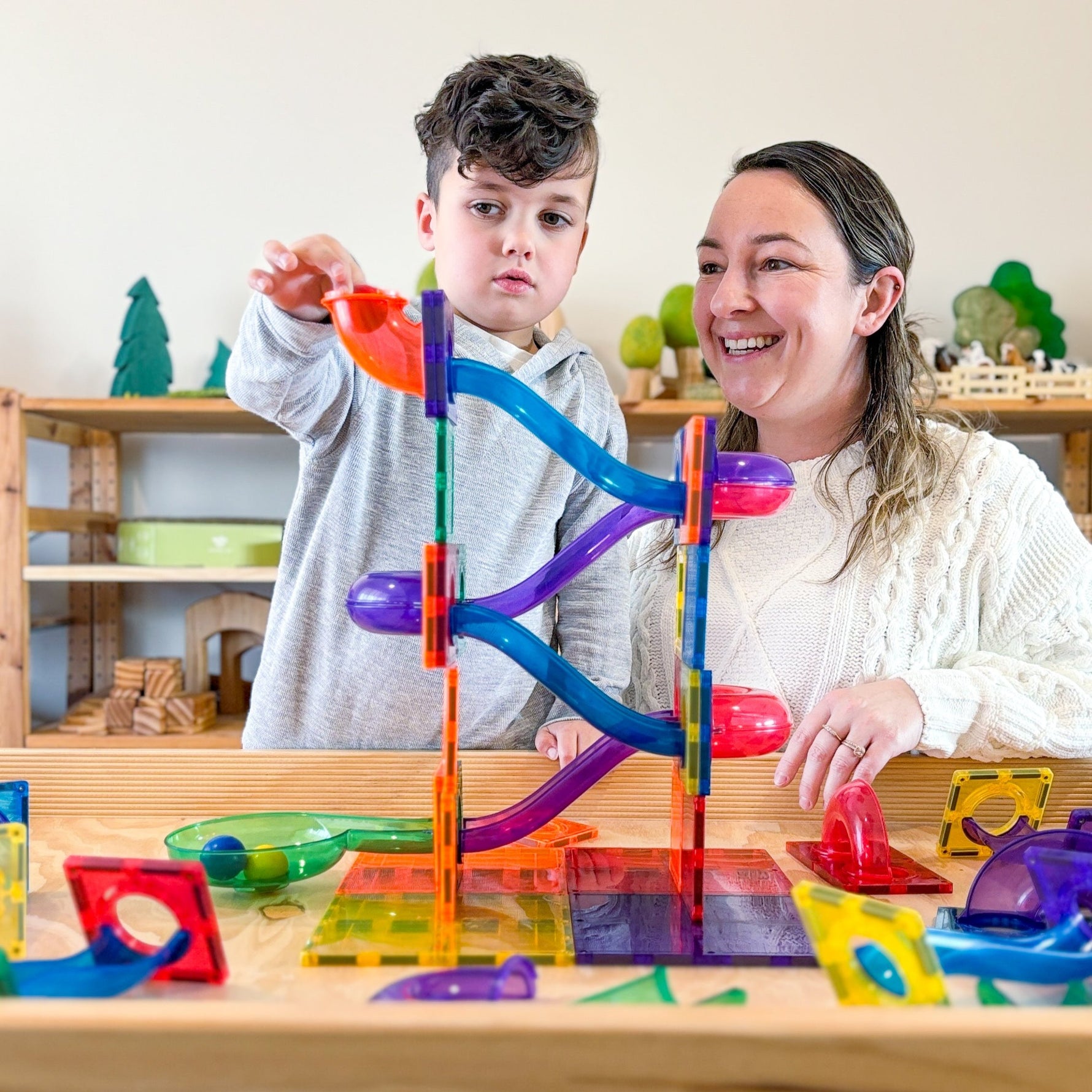 Mum and Son Child playing with marble ball run set up using magnetic tiles from Learn & Grow Toys