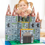 Girl playing with a castle made from magnetic tile toppers