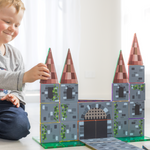 Boy playing with a castle made from magnetic tile toppers